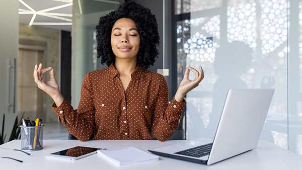 woman meditating at desk