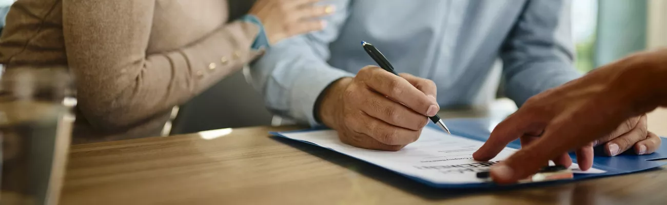 Couple signing documents