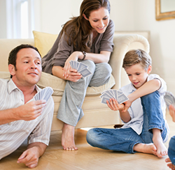 mom and dad playing cards with son