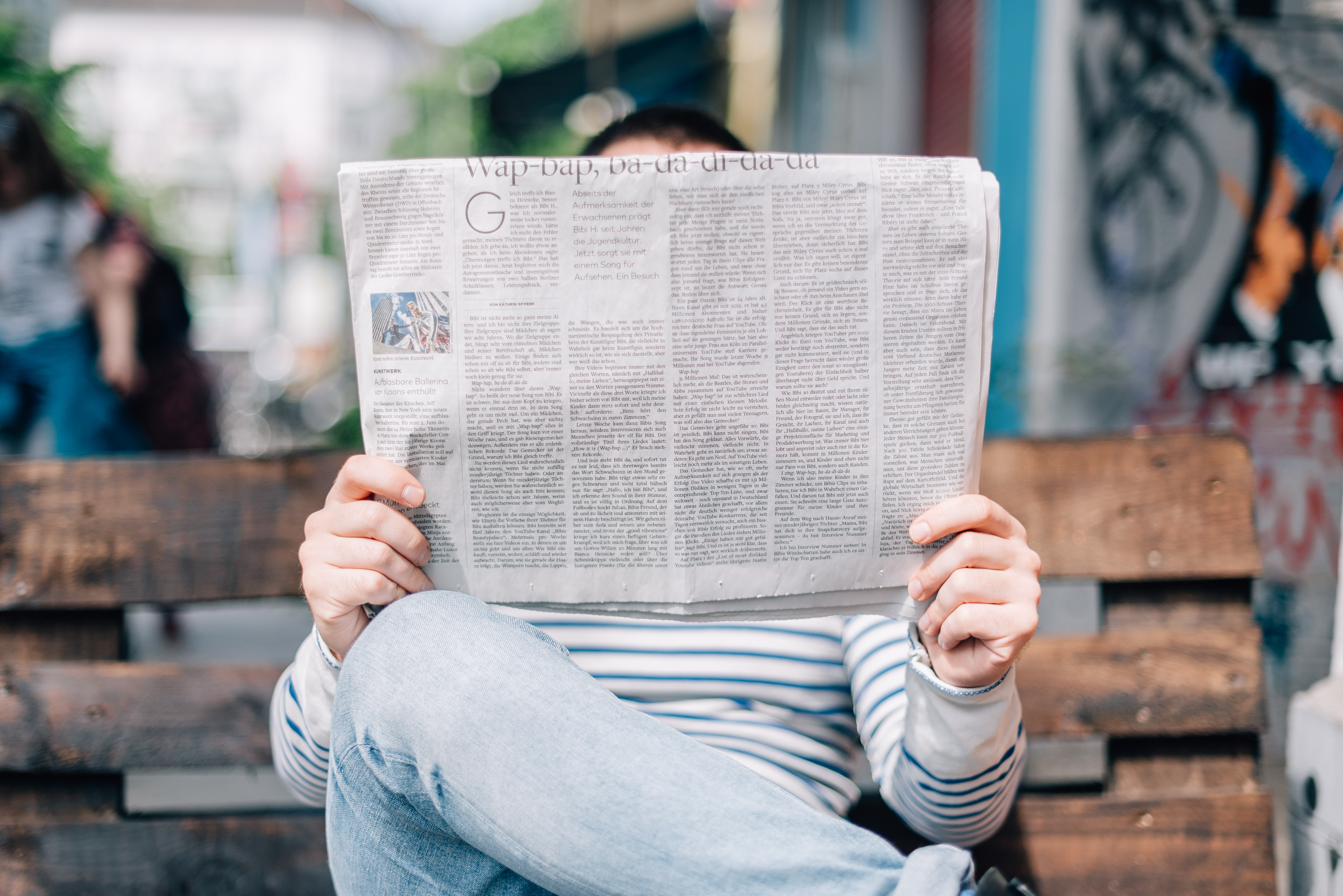 person holding newspaper icon